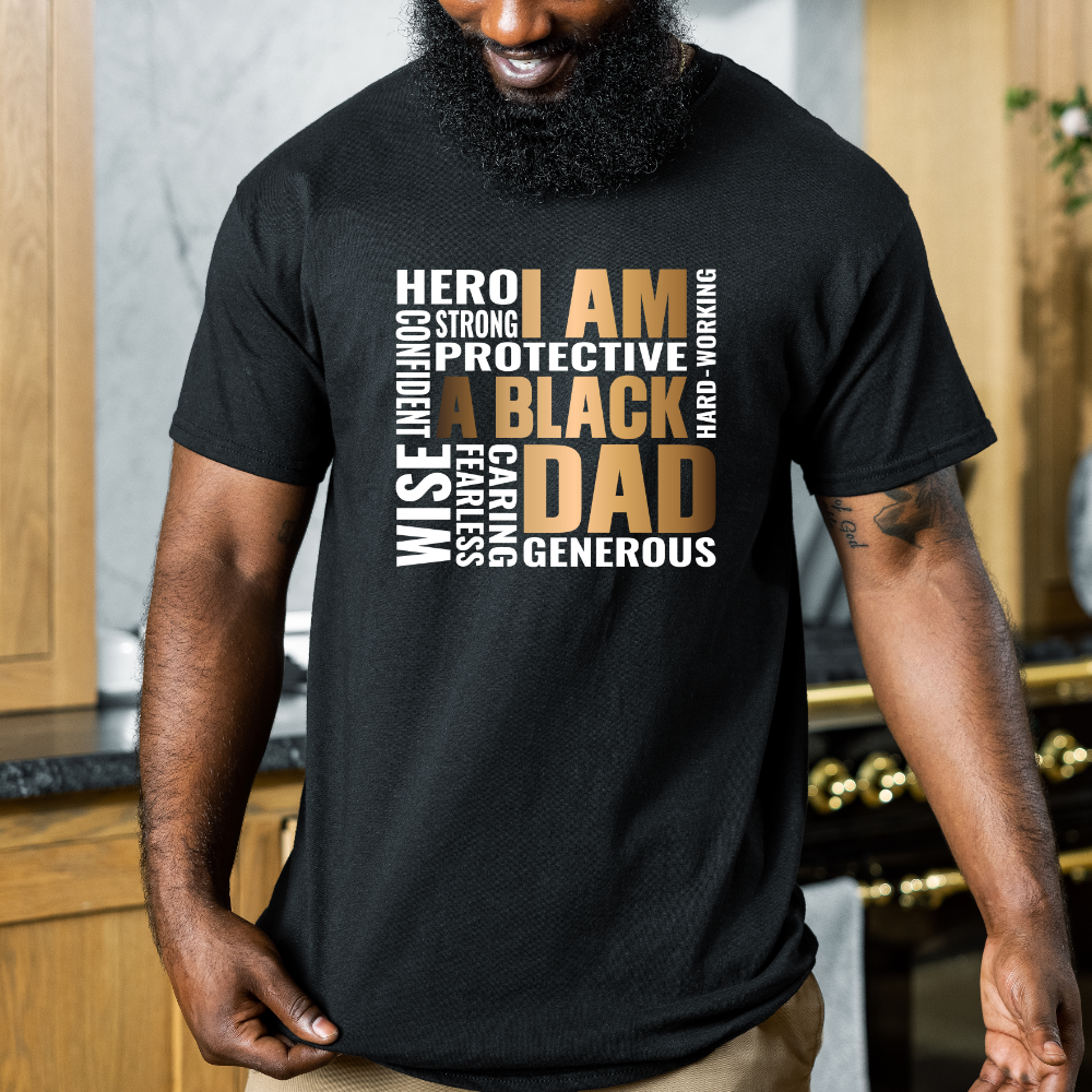 Man wearing a black t-shirt with text about being a black dad in a kitchen setting