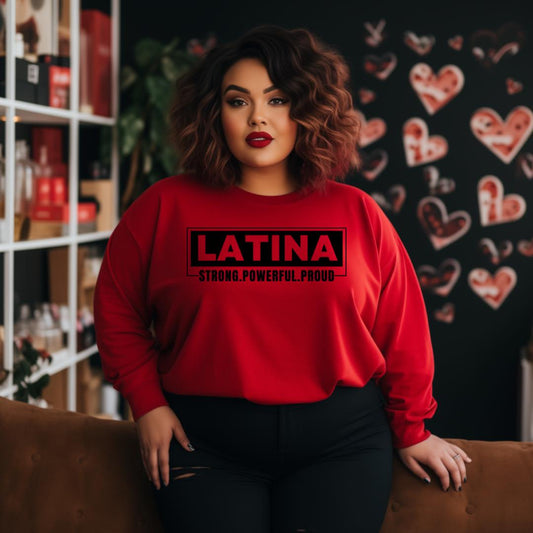 Woman wearing a red sweatshirt with 'LATINA STRONG. POWERFUL.